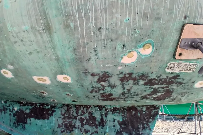 Slide: The Image of Hull of 1986 Irwin 43 sailboat with visible wear and repair patches. - 5