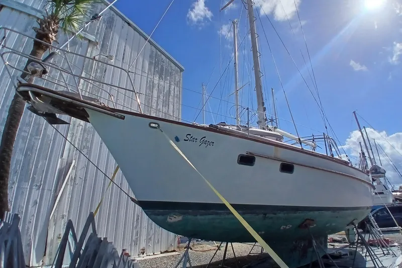 Slide: The Image of 1986 Irwin 43 sailboat named "Star Gazer" on dry dock under a bright blue sky. - 6