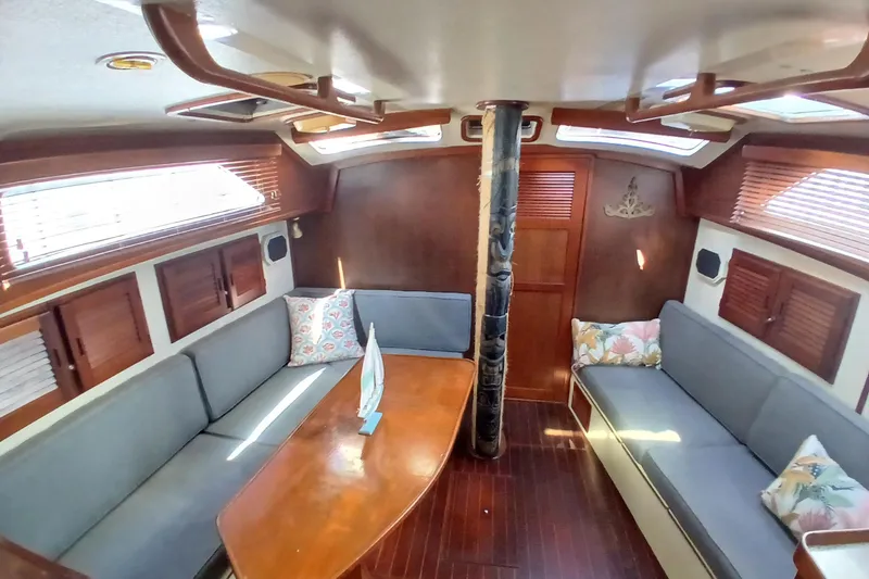 Slide: The Image of Interior of 1986 Irwin 43 sailboat with wooden finishes and cozy seating area. - 9