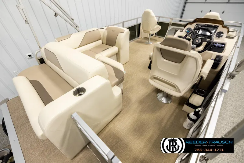 Slide: The Image of Interior of 2023 Avalon VEN BF boat with beige seating and steering console. - 12