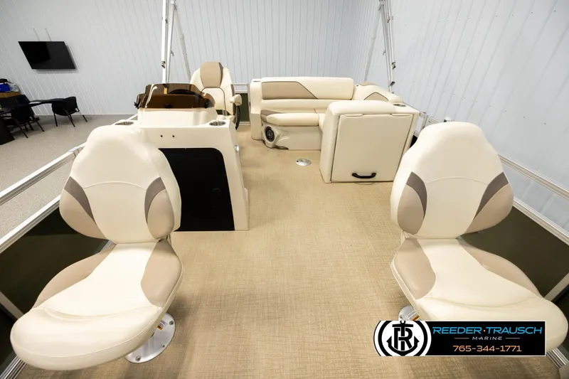 Slide: The Image of 2023 Avalon VEN BF boat interior with beige seating and steering console. - 13