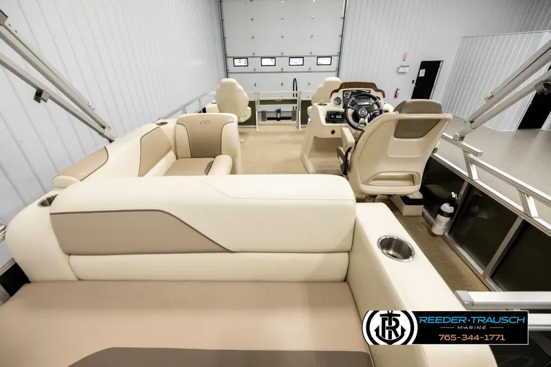 Slide: The Image of Interior of 2023 Avalon VEN BF boat with beige seating and steering console. - 16