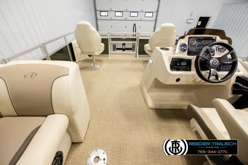 Slide: The Image of 2023 Avalon VEN BF boat interior with beige seating and modern dashboard controls. - 17