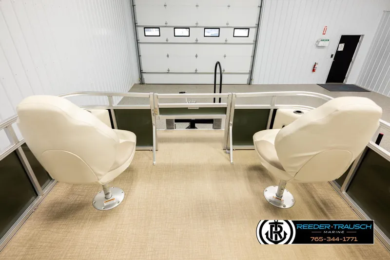 Slide: The Image of 2023 Avalon VEN BF boat interior with two white seats in a garage setting. - 18