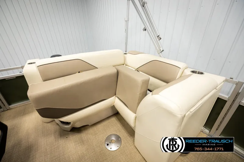Slide: The Image of 2023 Avalon VEN BF boat interior with beige seating and cup holders. - 21