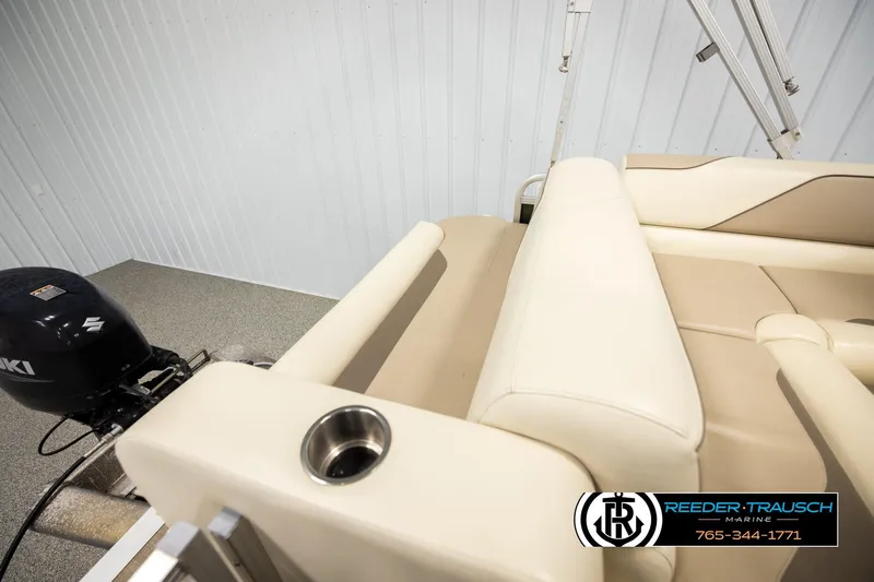 Slide: The Image of 2023 Avalon VEN BF boat interior with Suzuki motor, beige seating, and cup holder. - 22