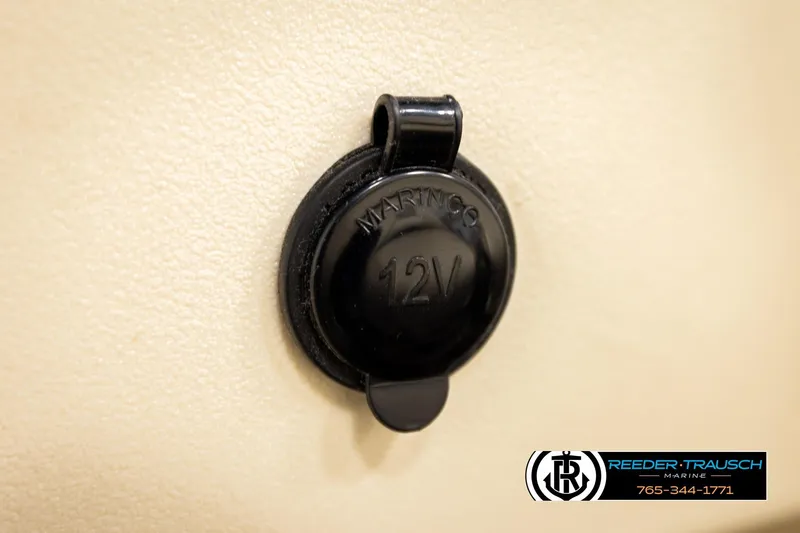 Slide: The Image of 12V marine power outlet on 2023 Avalon VEN BF boat, Reeder-Trausch Marine branding. - 35