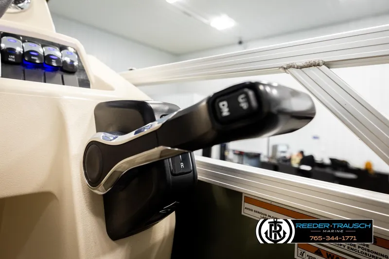 Slide: The Image of Close-up of 2023 Avalon VEN BF boat throttle control in a showroom setting. - 36
