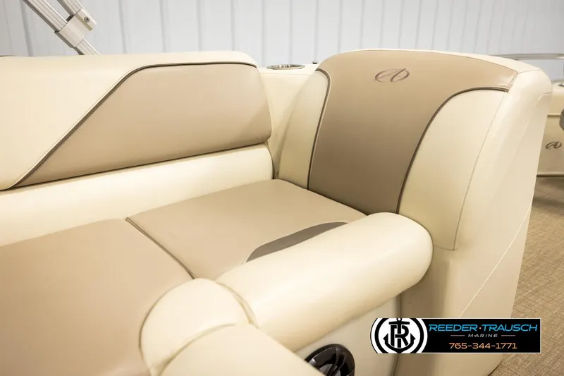 Slide: The Image of 2023 Avalon VEN BF boat interior with beige and tan seating, Reeder-Trausch Marine logo visible. - 38
