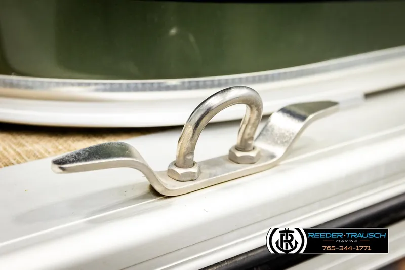 Slide: The Image of Close-up of a 2023 Avalon VEN BF boat cleat, featuring Reeder-Trausch Marine branding. - 51