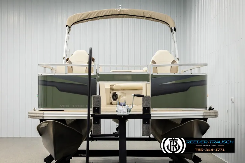 Slide: The Image of 2023 Avalon VEN BF pontoon boat in showroom, featuring beige seating and canopy. - 8