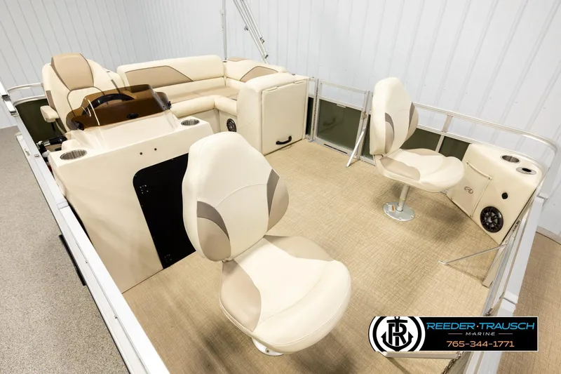 Slide: The Image of 2023 Avalon VEN BF boat interior with beige seating and steering console. - 9