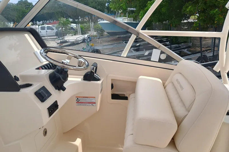 Slide: The Image of 2025 Grady-White Freedom 275 boat interior with steering wheel and seating. - 14