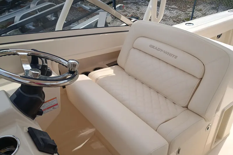 Slide: The Image of 2025 Grady-White Freedom 275 boat interior with steering wheel and cushioned seating. - 15