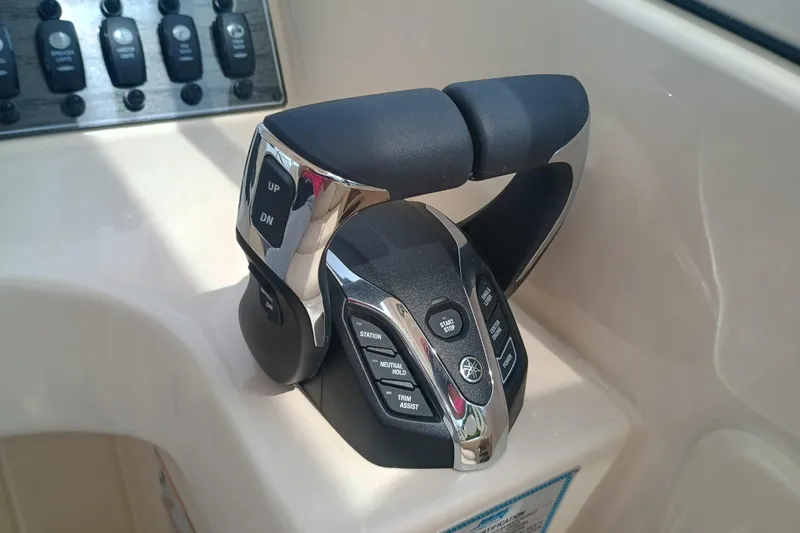 Slide: The Image of Throttle controls on a 2025 Grady-White Freedom 275 boat, featuring modern design and functionality. - 16