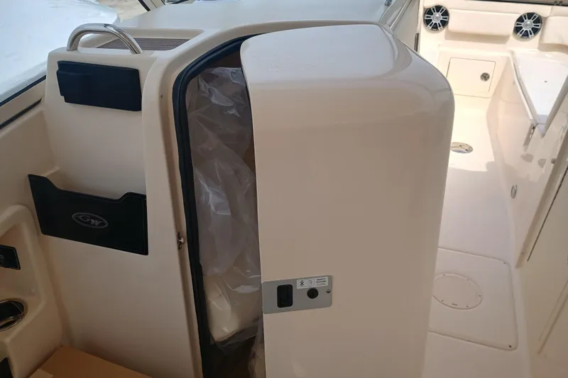 Slide: The Image of 2025 Grady-White Freedom 275 boat interior with storage compartment and speakers. - 20