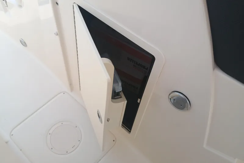 Slide: The Image of Open storage compartment on 2025 Grady-White Freedom 275 boat interior. - 21