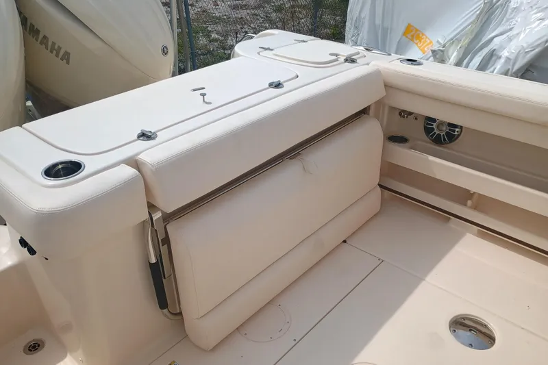 Slide: The Image of 2025 Grady-White Freedom 275 boat interior with cushioned seating and cup holders. - 8