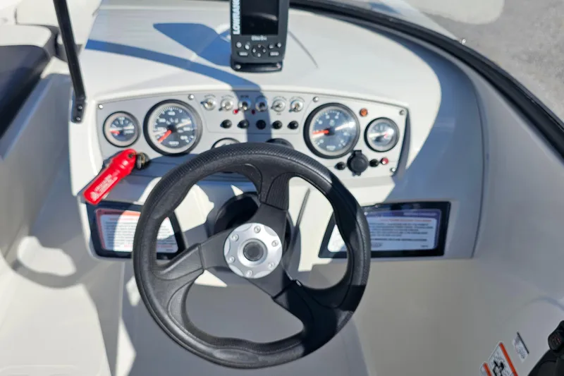 Slide: The Image of Steering console of a 2016 Tahoe 400 TF boat with gauges and controls. - 10
