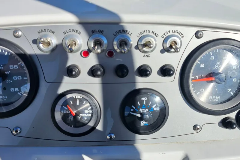 Slide: The Image of Dashboard of a 2016 Tahoe 400 TF boat with gauges and switches. - 12