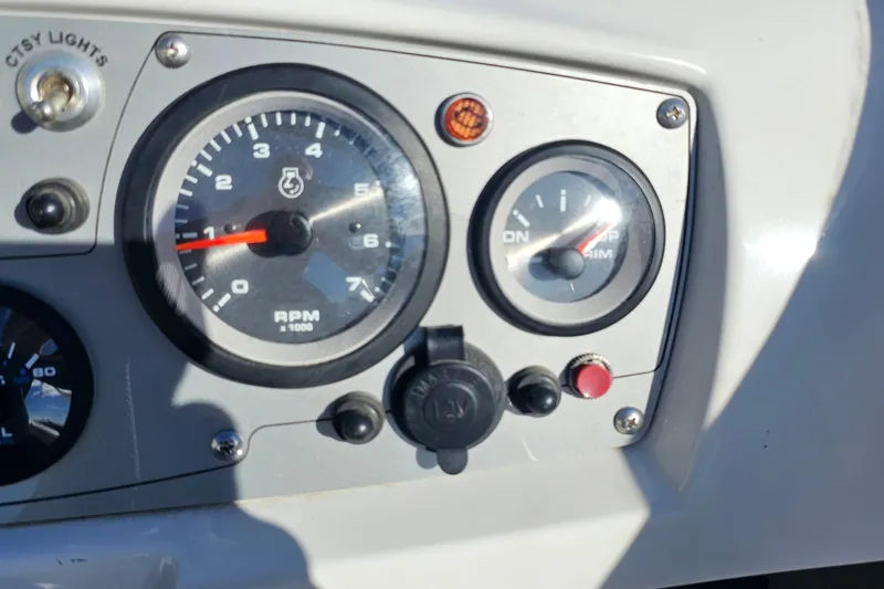 Slide: The Image of Dashboard of a 2016 Tahoe 400 TF boat with RPM and trim gauges. - 13
