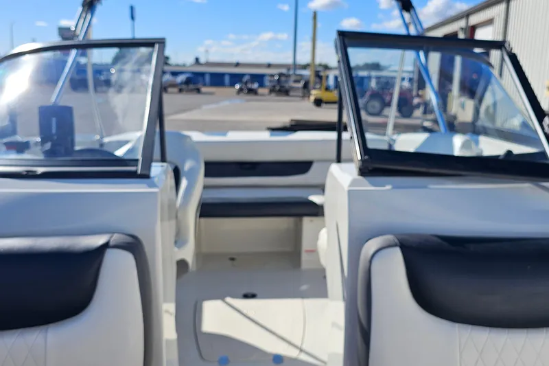 Slide: The Image of 2016 Tahoe 400 TF boat interior with open windshield and seating, parked outdoors. - 6