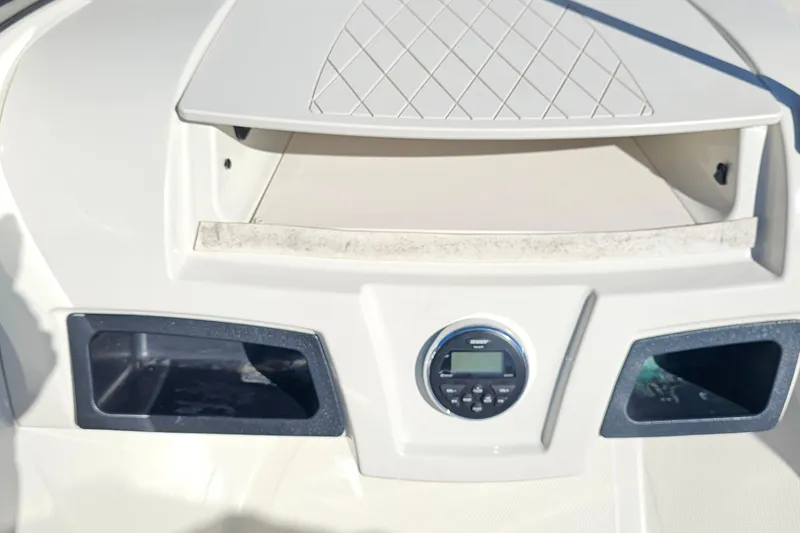Slide: The Image of 2016 Tahoe 400 TF boat dashboard with storage compartments and control panel. - 8
