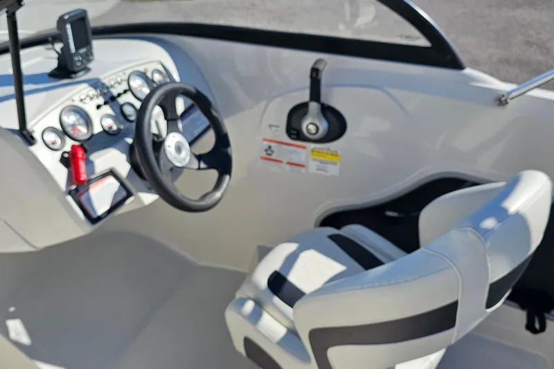 Slide: The Image of Interior of 2016 Tahoe 400 TF boat showing steering wheel and dashboard controls. - 9