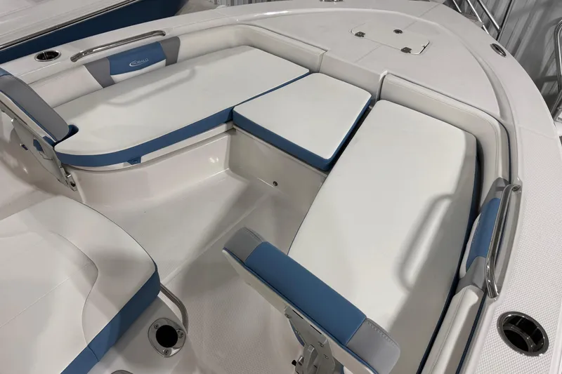 Slide: The Image of 2026 Robalo 206 Cayman boat interior with white and blue cushioned seating. - 15