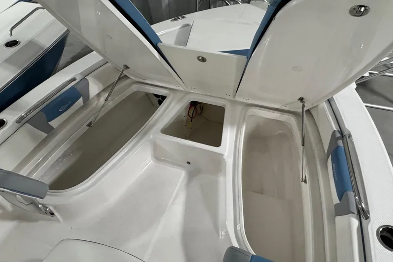Slide: The Image of 2026 Robalo 206 Cayman boat storage compartments with open hatches, showcasing spacious interior design. - 16