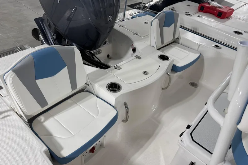 Slide: The Image of 2026 Robalo 206 Cayman boat interior with blue and white seating and motor. - 8