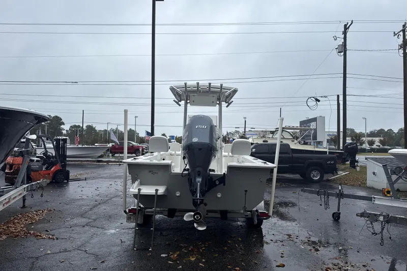 Slide: The Image of 2017 Bay Rider 2260 FS Skiff boat on trailer in parking lot, rear view. - 2