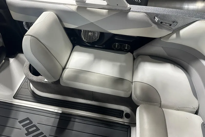 Slide: The Image of 2016 Malibu Wakesetter 23 LSV interior seating with gray upholstery and cup holders. - 11
