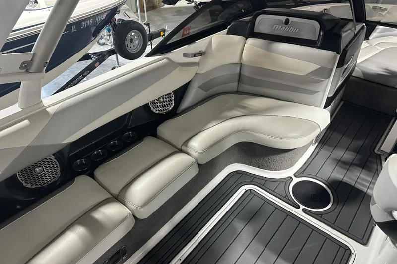 Slide: The Image of 2016 Malibu Wakesetter 23 LSV interior with white seating and black flooring. - 12