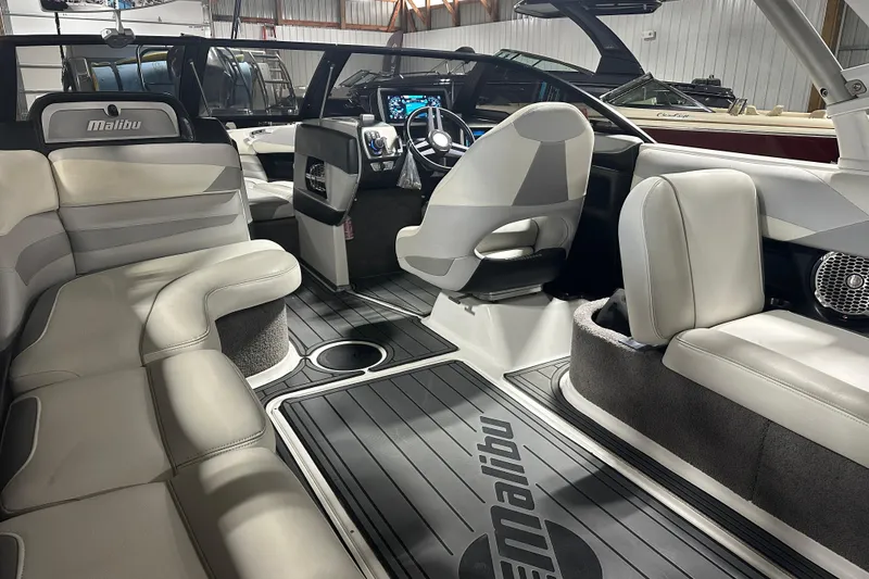 Slide: The Image of Interior of a 2016 Malibu Wakesetter 23 LSV boat with luxurious seating and modern dashboard. - 16