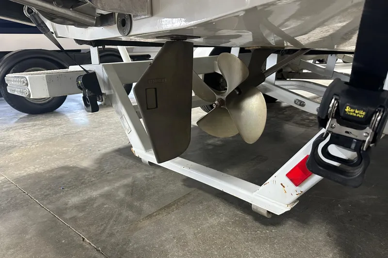 Slide: The Image of 2016 Malibu Wakesetter 23 LSV boat propeller and trailer detail in a garage. - 5