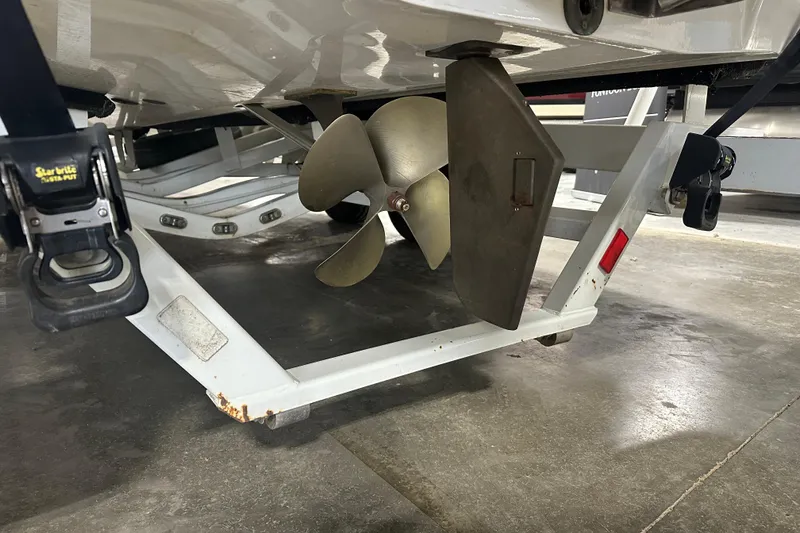 Slide: The Image of 2016 Malibu Wakesetter 23 LSV boat propeller and rudder on trailer. - 6