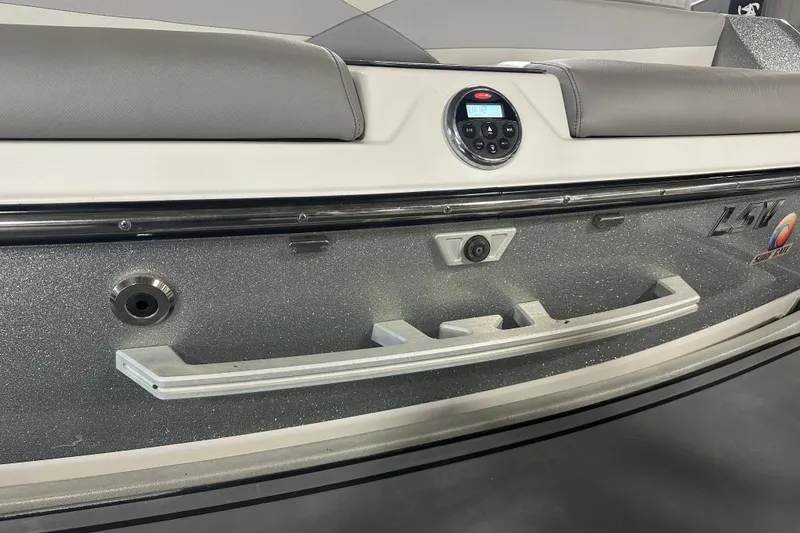 Slide: The Image of 2016 Malibu Wakesetter 23 LSV boat rear view with audio controls and sleek design. - 7