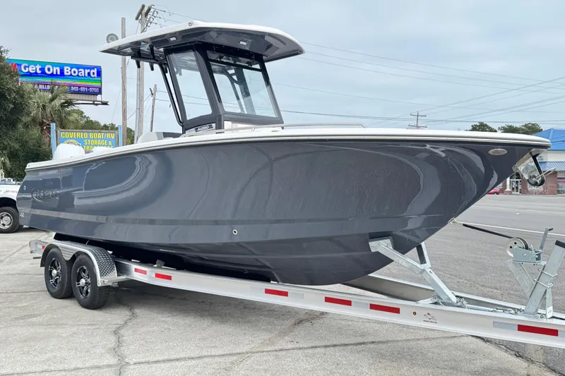 The Image of 2026 Robalo R250 Center Console boat on trailer, parked outdoors. - 0