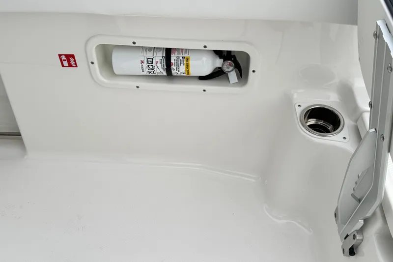 Slide: The Image of 2026 Robalo R250 Center Console boat interior with fire extinguisher compartment. - 16