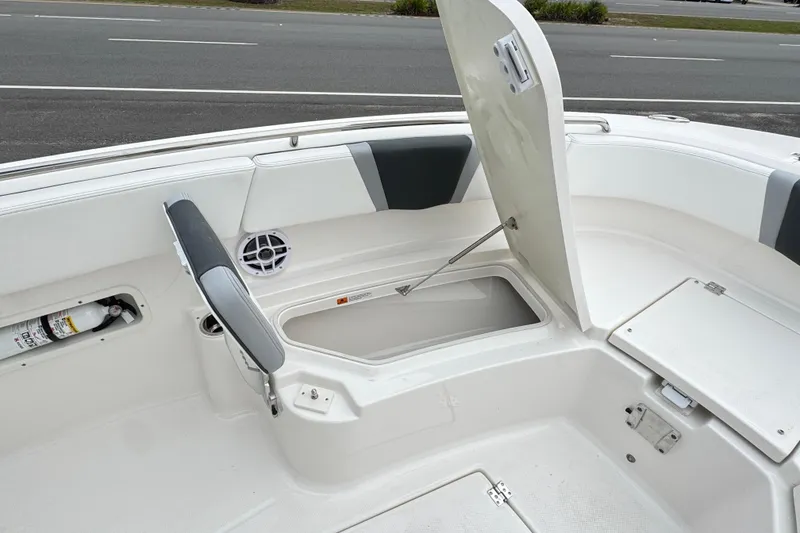 Slide: The Image of 2026 Robalo R250 Center Console boat interior with open storage compartments. - 17