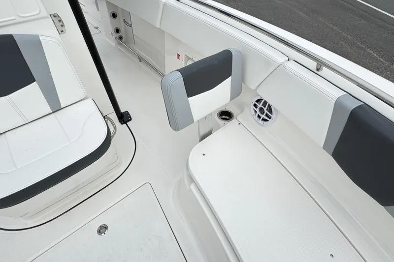 Slide: The Image of 2026 Robalo R250 Center Console boat interior with cushioned seating and speaker. - 18