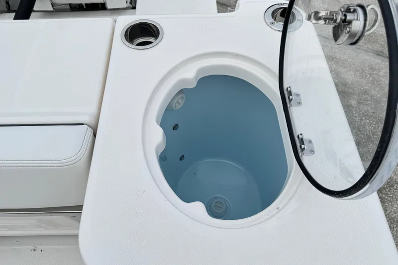 Slide: The Image of Open livewell on 2026 Robalo R250 Center Console boat, featuring white interior and cup holder. - 26