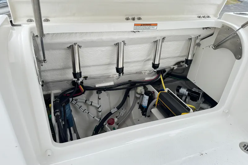 Slide: The Image of 2026 Robalo R250 Center Console boat engine compartment with hydraulic and electrical components. - 28