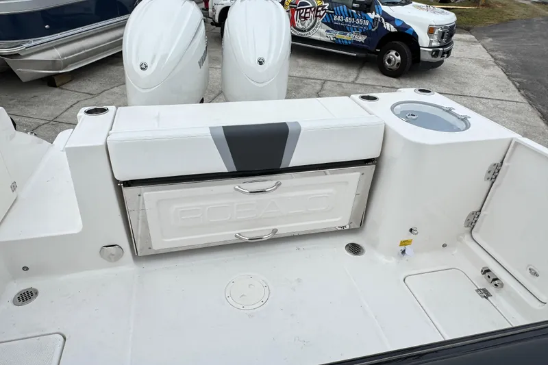 Slide: The Image of 2026 Robalo R250 Center Console boat with dual engines and storage compartments. - 31