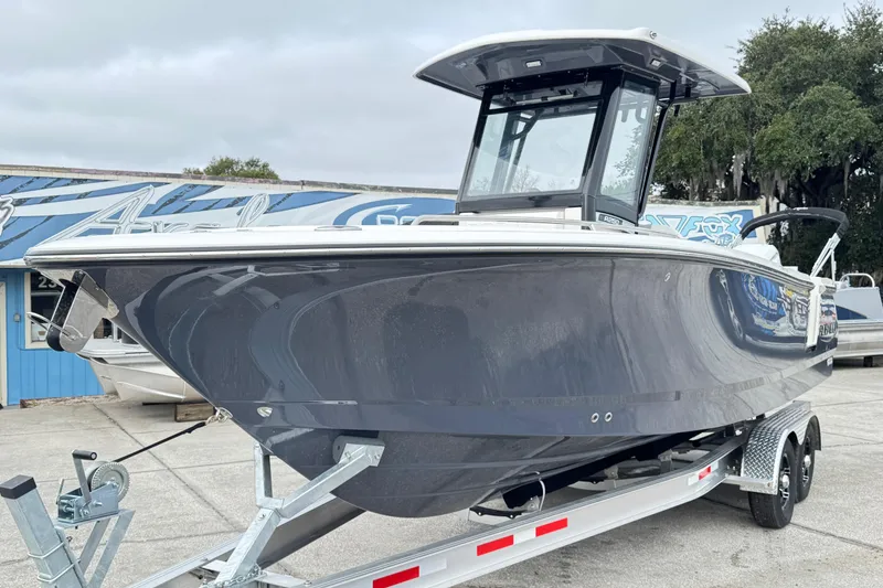 Slide: The Image of 2026 Robalo R250 Center Console boat on trailer, sleek design, outdoor display. - 35