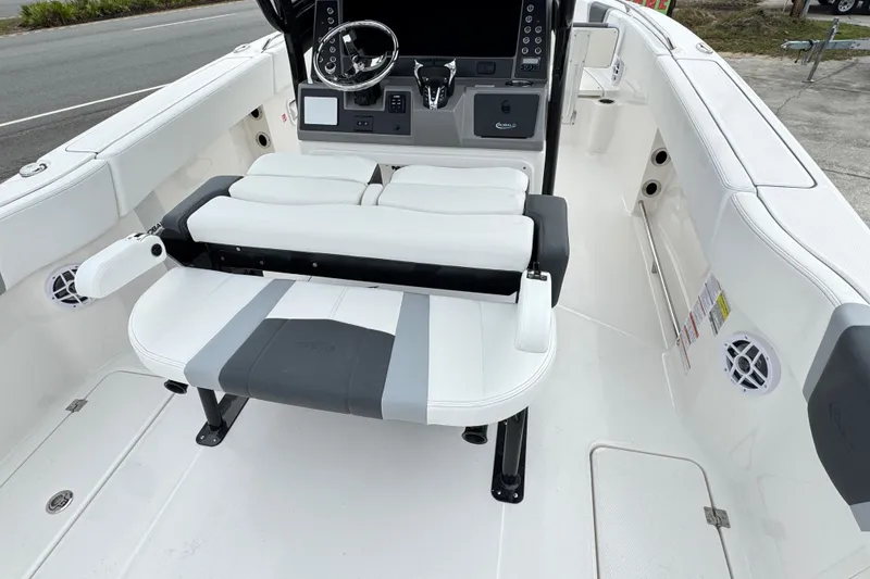 Slide: The Image of 2026 Robalo R250 Center Console boat interior with white seating and modern dashboard. - 5