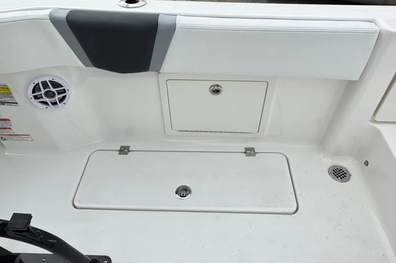 Slide: The Image of 2026 Robalo R250 Center Console boat interior with storage compartments and speaker. - 9