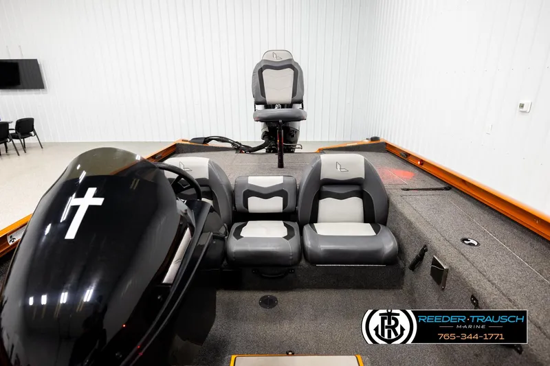 Slide: The Image of 2022 Lowe Stinger 178 boat interior with seating and motor, displayed indoors. - 17