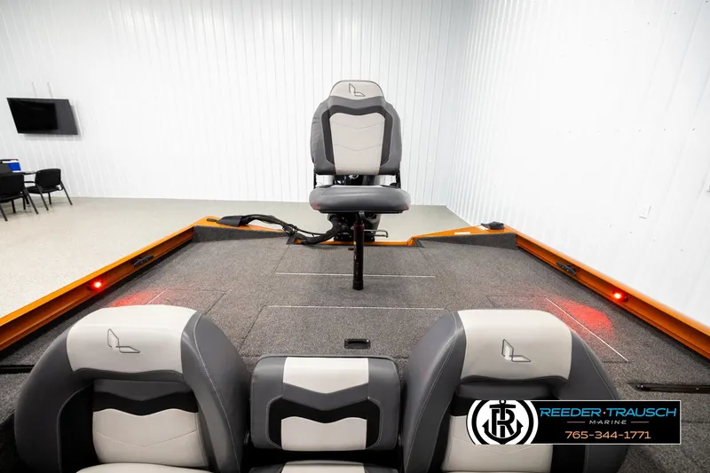 Slide: The Image of 2022 Lowe Stinger 178 boat interior with seating, displayed at Reeder Trausch Marine showroom. - 18